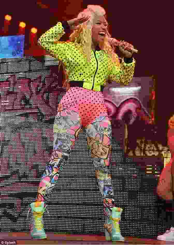 Nicki Minaj Performing On Stage, Wearing A Brightly Colored Outfit And Surrounded By Dancers Nicki Minaj (People In The News)